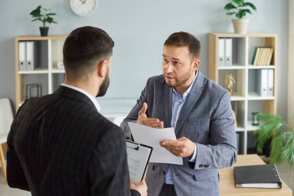 Dissatisfied business people colleagues disputing having disagreement at workplace.
