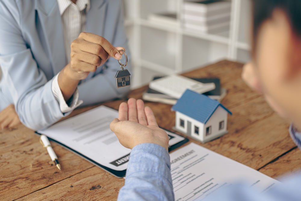 A real estate agent and a customer discuss a contract to buy insurance or a loan on real estate or property.
